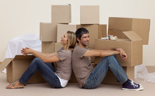 Professional movers handling furniture in Charingcross